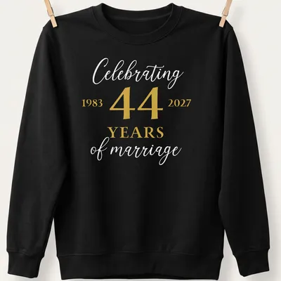 Elegant tee celebrating 44 years of marriage with modern typography in gold and white. — printed on a unisex sweatshirt