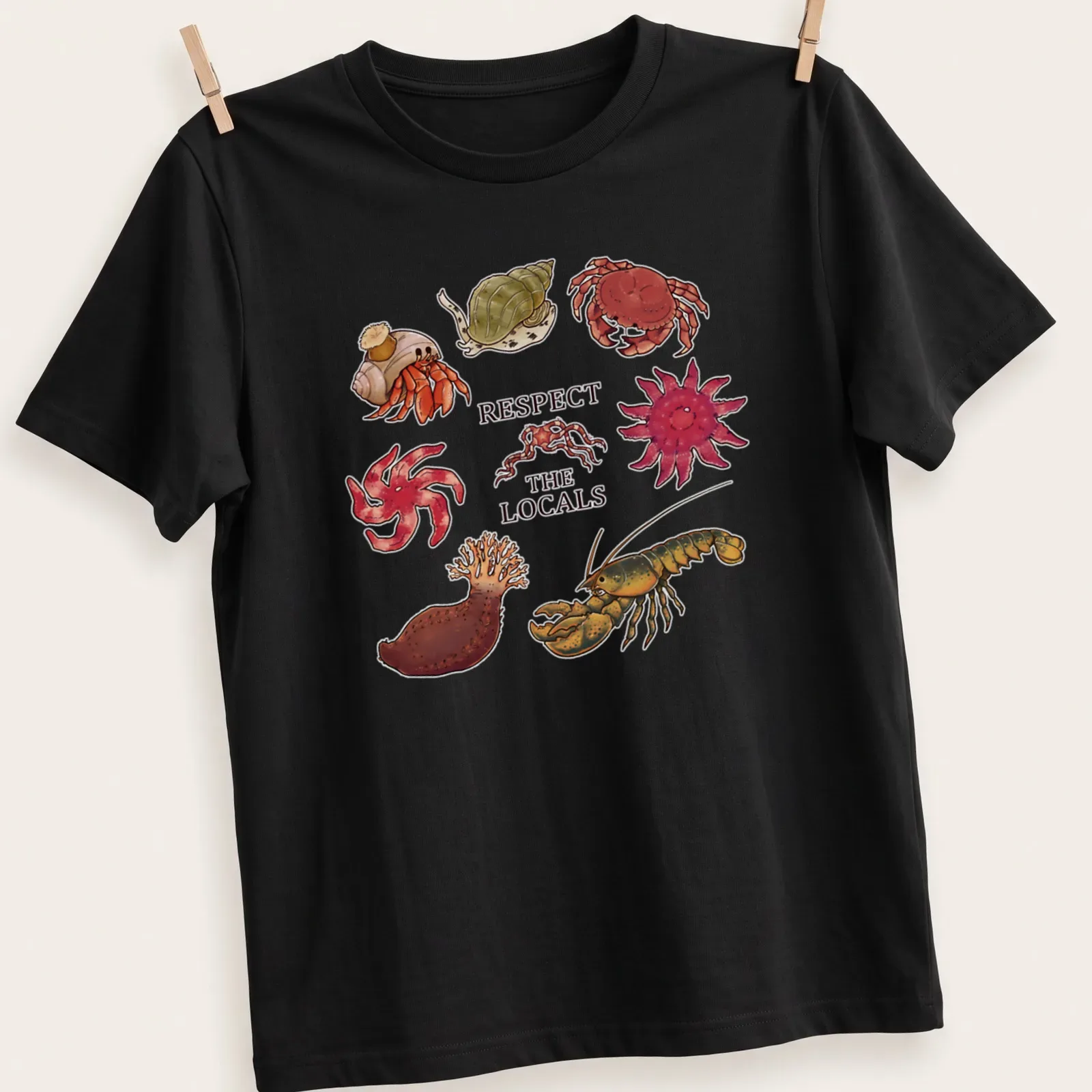Illustrative t-shirt featuring Atlantic Canada invertebrates with colorful text above — printed on a unisex t-shirt