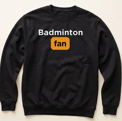 Bold typography Badminton Fan T-shirt in black, orange, and white — printed on a unisex sweatshirt