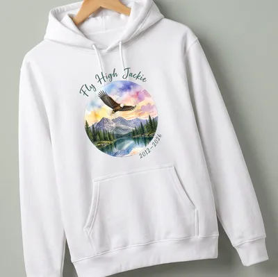 Watercolor print of a bald eagle with Fly High Jackie tribute text in colorful lettering — printed on a unisex hoodie