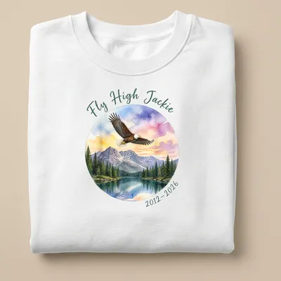 Watercolor print of a bald eagle with Fly High Jackie tribute text in colorful lettering — printed on a unisex sweatshirt