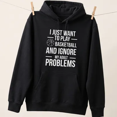 Playful basketball t-shirt with text about ignoring adult problems and a player in action — printed on a unisex hoodie
