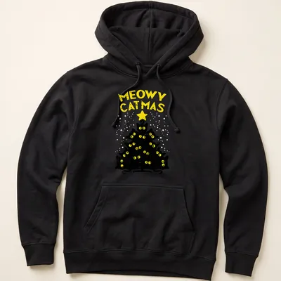Funny holiday T-shirt featuring black cats around a Christmas tree with text 'Meowy Catmas' — printed on a unisex hoodie