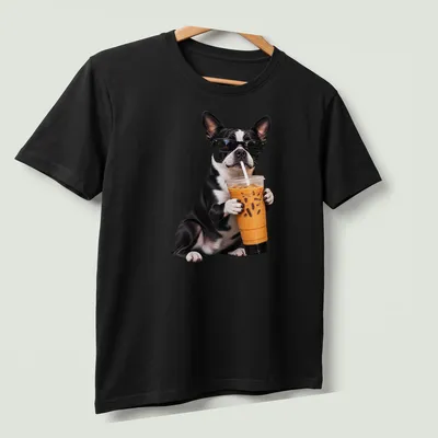 Funny illustration of a Boston Terrier holding iced coffee with a playful expression — printed on a unisex t-shirt (angled view)
