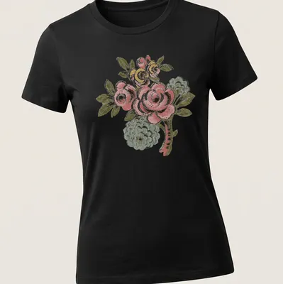 Vintage folk art t-shirt featuring a pink rose bouquet and colorful accents — printed on a women's shirt