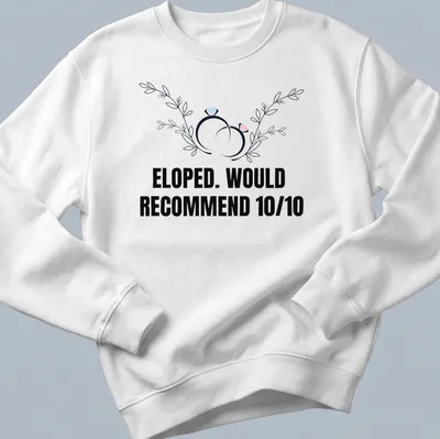 Botanical design featuring wedding rings with the text 'ELOPED. WOULD RECOMMEND 10/10' — printed on a unisex sweatshirt