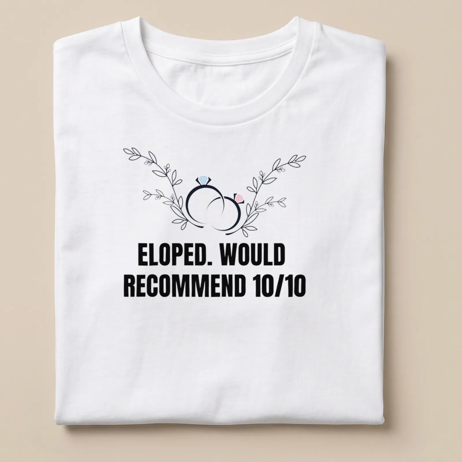 Botanical design featuring wedding rings with the text 'ELOPED. WOULD RECOMMEND 10/10' — printed on a unisex t-shirt