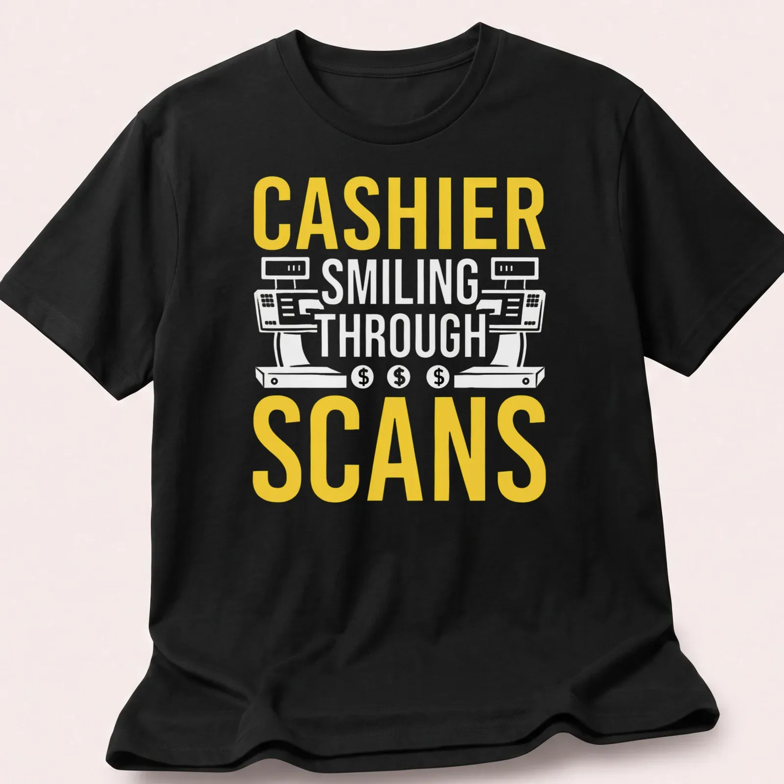 Bold typography T-shirt with the text 'CASHIER SMILING THROUGH SCANS' in yellow and white — printed on a unisex t-shirt