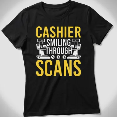 Bold typography T-shirt with the text 'CASHIER SMILING THROUGH SCANS' in yellow and white — printed on a women's shirt