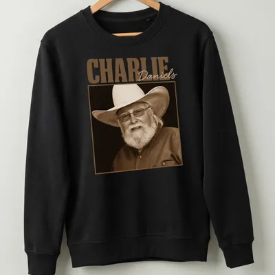 Sepia portrait of Charlie Daniels with text below in classic font — printed on a unisex sweatshirt