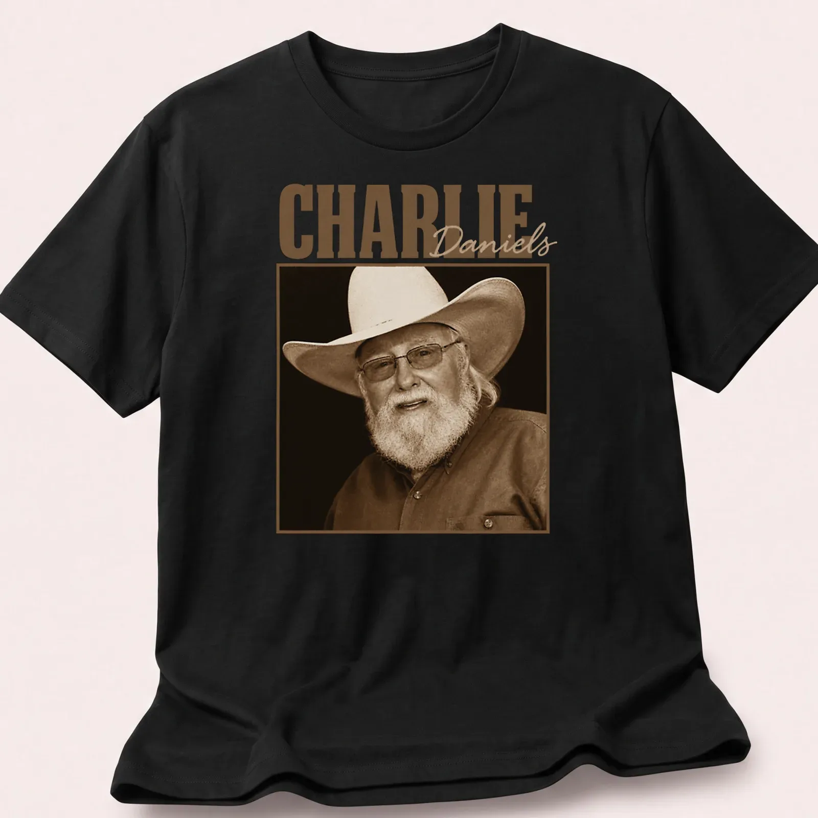 Sepia portrait of Charlie Daniels with text below in classic font — printed on a unisex t-shirt