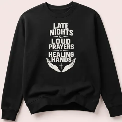 T-shirt with bold text reading 'Late Nights Loud Prayers Healing Hands' with religious symbols — printed on a unisex sweatshirt