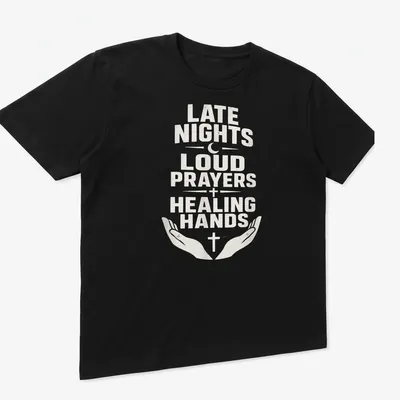 T-shirt with bold text reading 'Late Nights Loud Prayers Healing Hands' with religious symbols — printed on a unisex t-shirt (angled view)