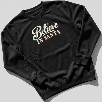 Vintage script Christmas shirt with Believe IN SANTA text in white, gold, red, and black. — printed on a unisex sweatshirt