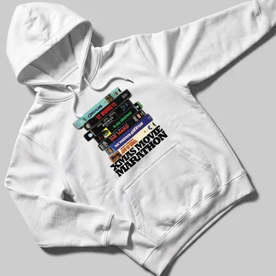 Retro design featuring VHS tapes and Xmas Movie Marathon text. — printed on a unisex hoodie
