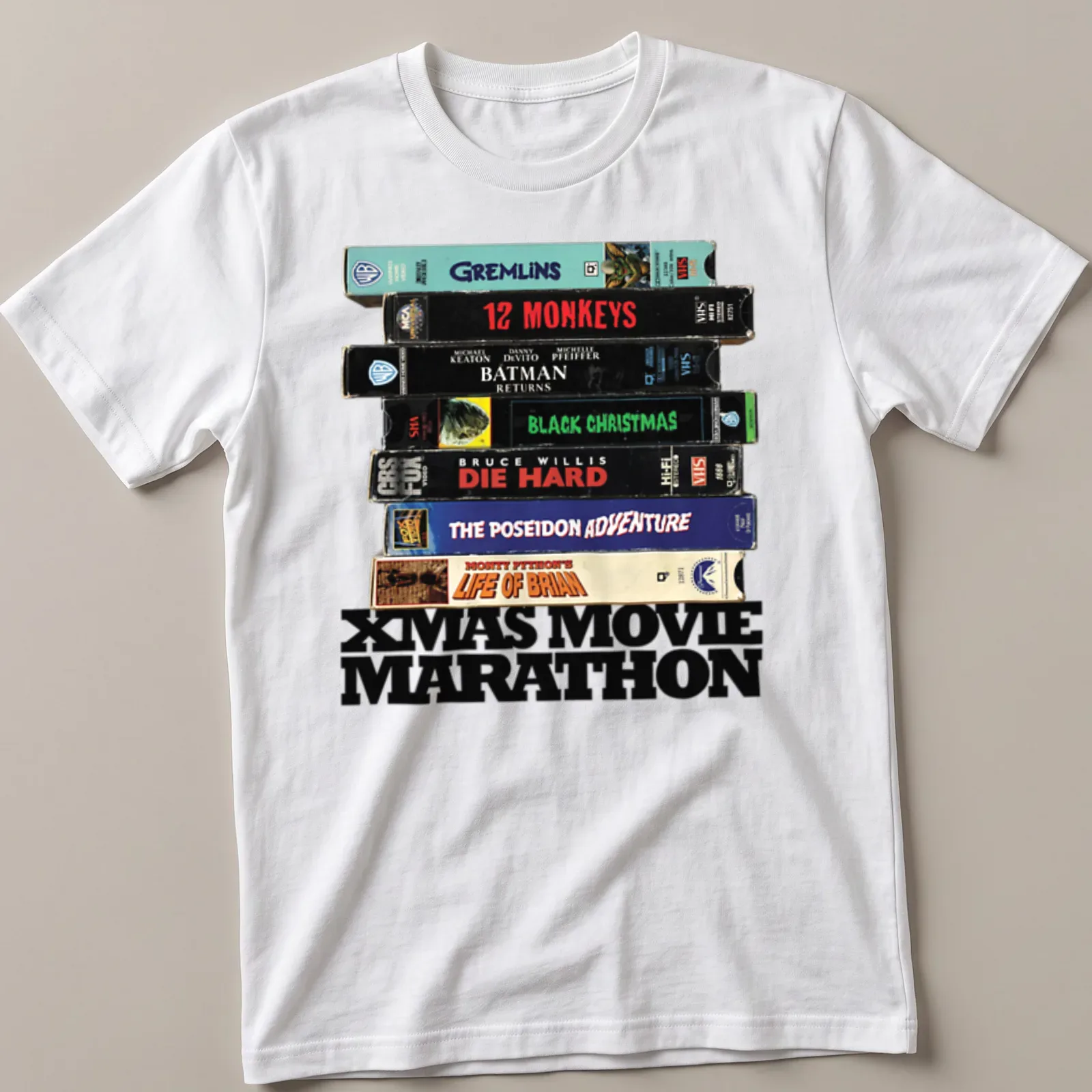 Retro design featuring VHS tapes and Xmas Movie Marathon text. — printed on a unisex t-shirt