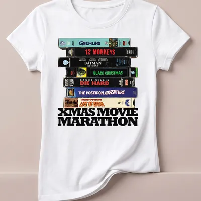 Retro design featuring VHS tapes and Xmas Movie Marathon text. — printed on a women's shirt