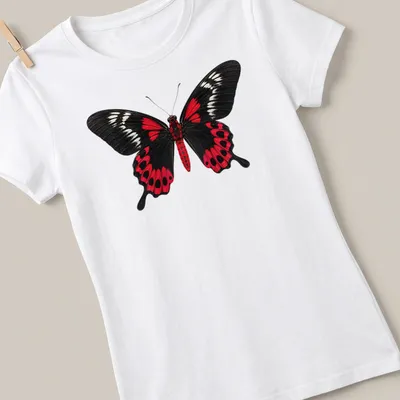 Realistic print of a Crimson Rose Butterfly on a black background with red and white details. — printed on a women's shirt