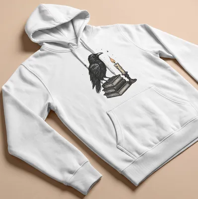 Vintage illustration of a crow on books next to a candle, in black, white, orange, and brown — printed on a unisex hoodie