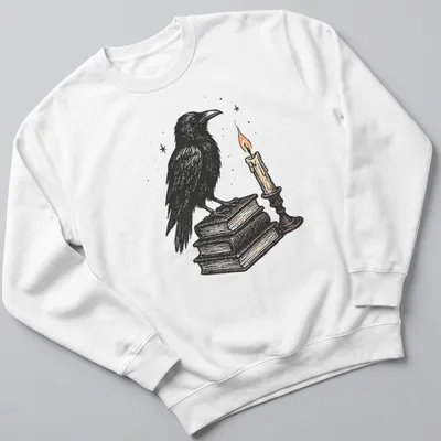 Vintage illustration of a crow on books next to a candle, in black, white, orange, and brown — printed on a unisex sweatshirt