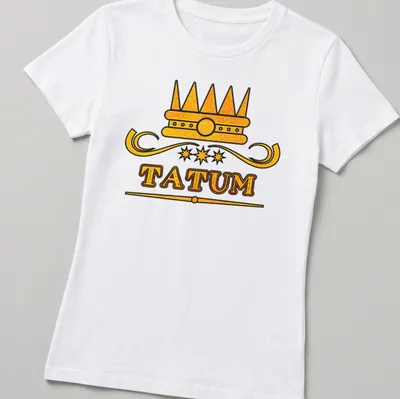 Bold typography with the name Tatum and a crown above it in gold and black. — printed on a women's shirt