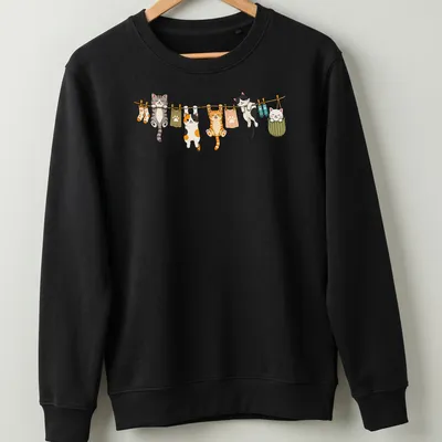 Kawaii print of cute cats hanging in playful poses in various colors — printed on a unisex sweatshirt