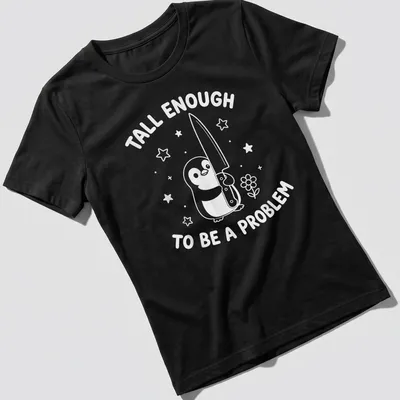 Kawaii line-art penguin holding a knife with humorous text about height. — printed on a women's shirt
