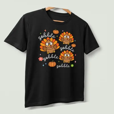 Kawaii cute turkey with cheerful expression and Gobble Gobble text in vibrant colors — printed on a unisex t-shirt (angled view)