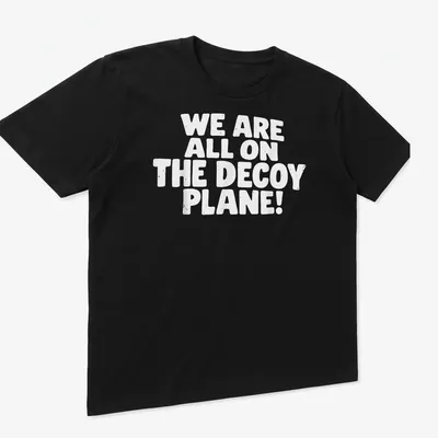 Bold typography shirt saying 'WE ARE ALL ON THE DECoy PLANE!' in white — printed on a unisex t-shirt (angled view)