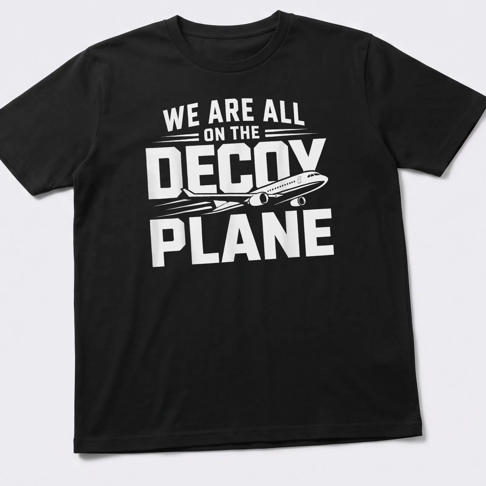 Bold typography shirt with the phrase We Are All On The Decoy Plane in white and black — printed on a unisex t-shirt