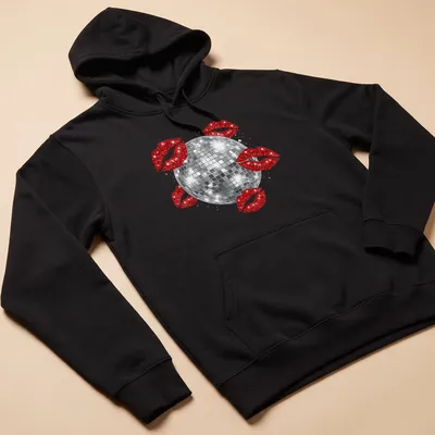 Illustration of a disco ball above red kissing lips in a glittery style. — printed on a unisex hoodie
