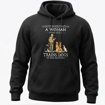 Realistic illustration of a woman training dogs with motivational text — printed on a unisex hoodie