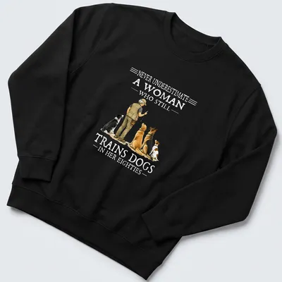Realistic illustration of a woman training dogs with motivational text — printed on a unisex sweatshirt