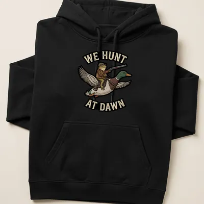 Cartoon frog riding a duck with the text 'We Hunt At Dawn' in vibrant colors — printed on a unisex hoodie