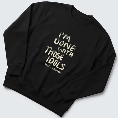 Text-based design featuring dusty bibles with the quote 'I'm Done With Those Idols Josiah Queen' — printed on a unisex sweatshirt