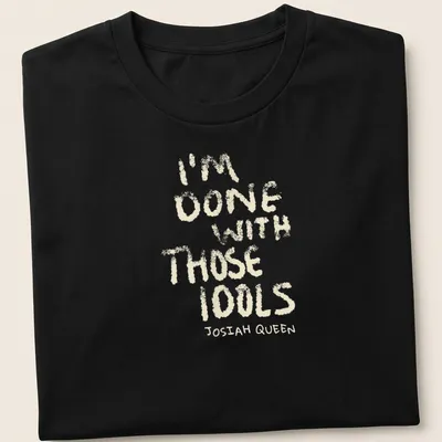 Text-based design featuring dusty bibles with the quote 'I'm Done With Those Idols Josiah Queen'