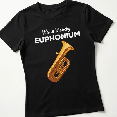 Cartoon euphonium t-shirt featuring humorous text in gold and yellow on black — printed on a women's shirt