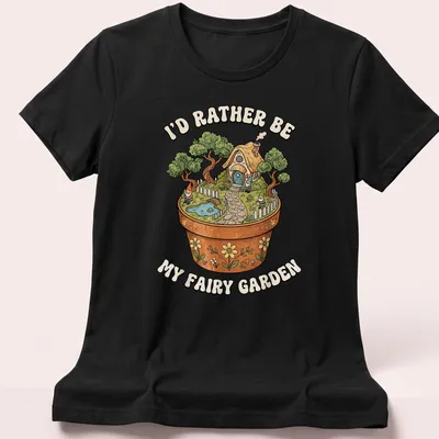 Colorful illustration of a fairy garden with the text I'd Rather Be My Fairy Garden — printed on a women's shirt