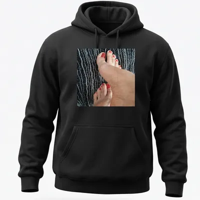 Photographic T-shirt featuring feet with red nail polish on a black background — printed on a unisex hoodie