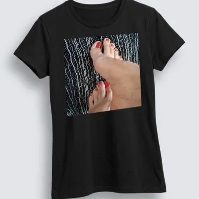 Photographic T-shirt featuring feet with red nail polish on a black background — printed on a women's shirt