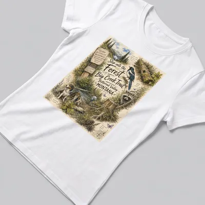 Vintage illustrated T-shirt depicting a forest scene in Montana with wildlife — printed on a women's shirt