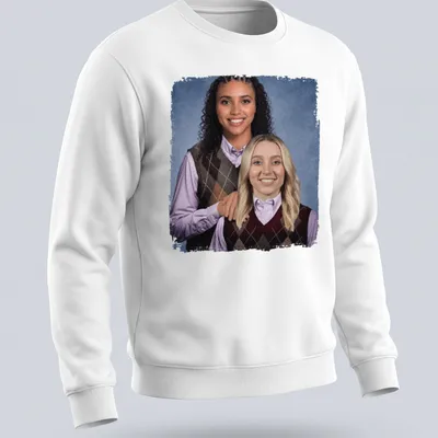 Photographic design of Paige Bueckers and Azzi Fudd playing basketball in vibrant colors — printed on a unisex sweatshirt