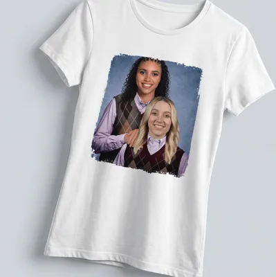Photographic design of Paige Bueckers and Azzi Fudd playing basketball in vibrant colors — printed on a women's shirt