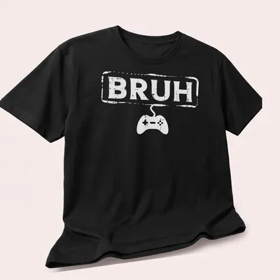 Bold typography Gamer Bruh shirt featuring a video game controller in white — printed on a unisex t-shirt (angled view)