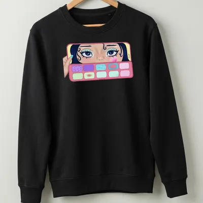 Colorful illustration of a girl applying makeup with eyeshadow palettes — printed on a unisex sweatshirt