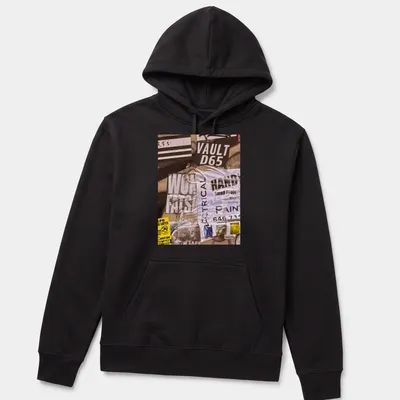 Graffiti-inspired t-shirt with bold text and urban collage design in black, white, yellow, and gray — printed on a unisex hoodie