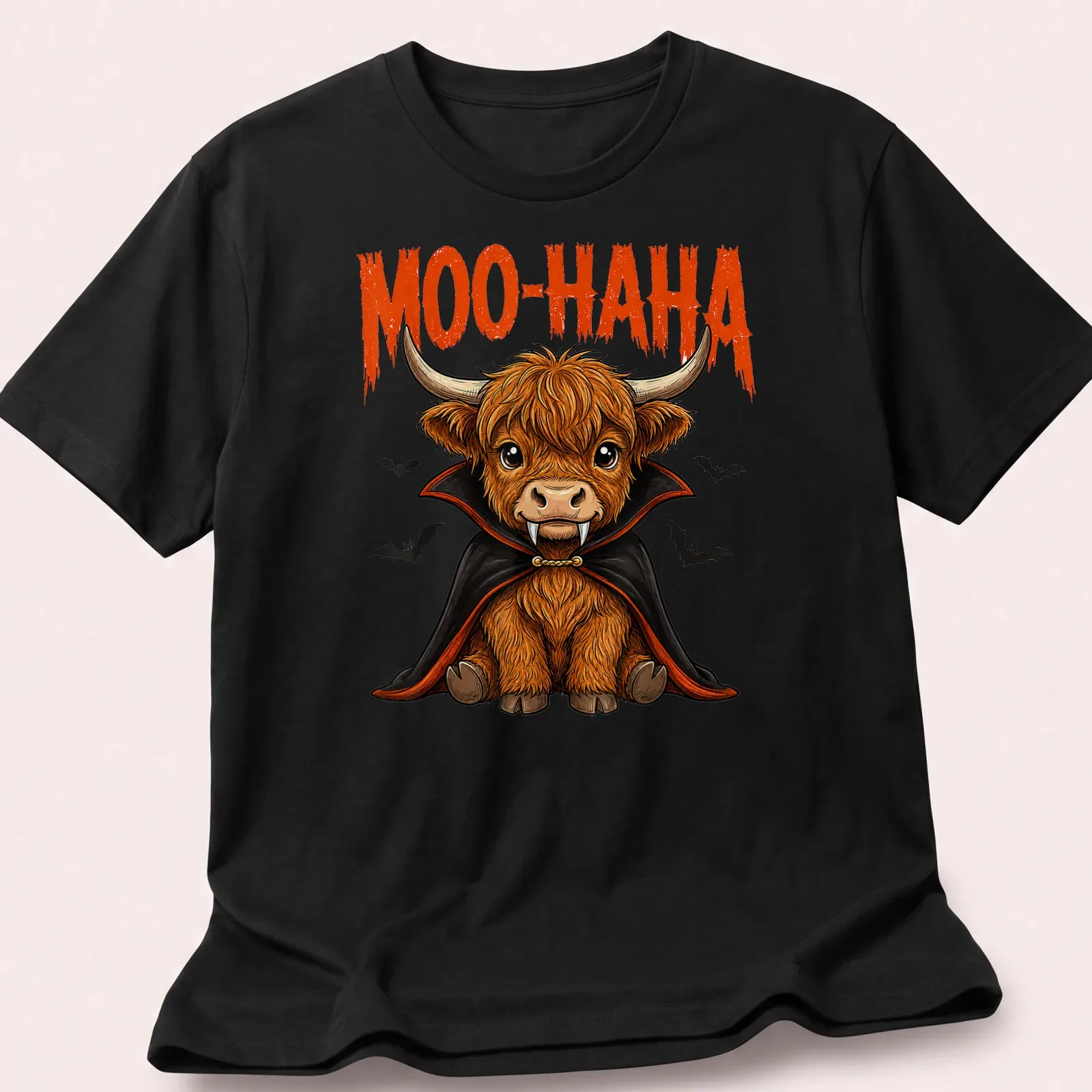 Cartoon Highland cow vampire with 'MOO-HA-HA' text, in orange and black colors — printed on a unisex t-shirt