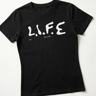 Bold typography t-shirt featuring 'Keinemusik Merch' text — printed on a women's shirt