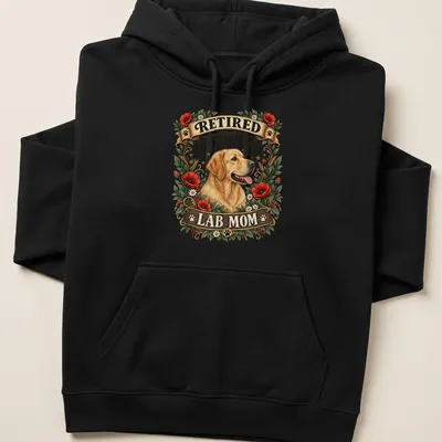 Vintage floral t-shirt with the text RETIRED PROMOTED TO STAY AT HOME LAB MOM and a yellow Labrador illustration — printed on a unisex hoodie