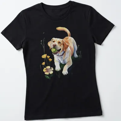 Colorful illustration of a smiling Labrador dog surrounded by flowers and text — printed on a women's shirt